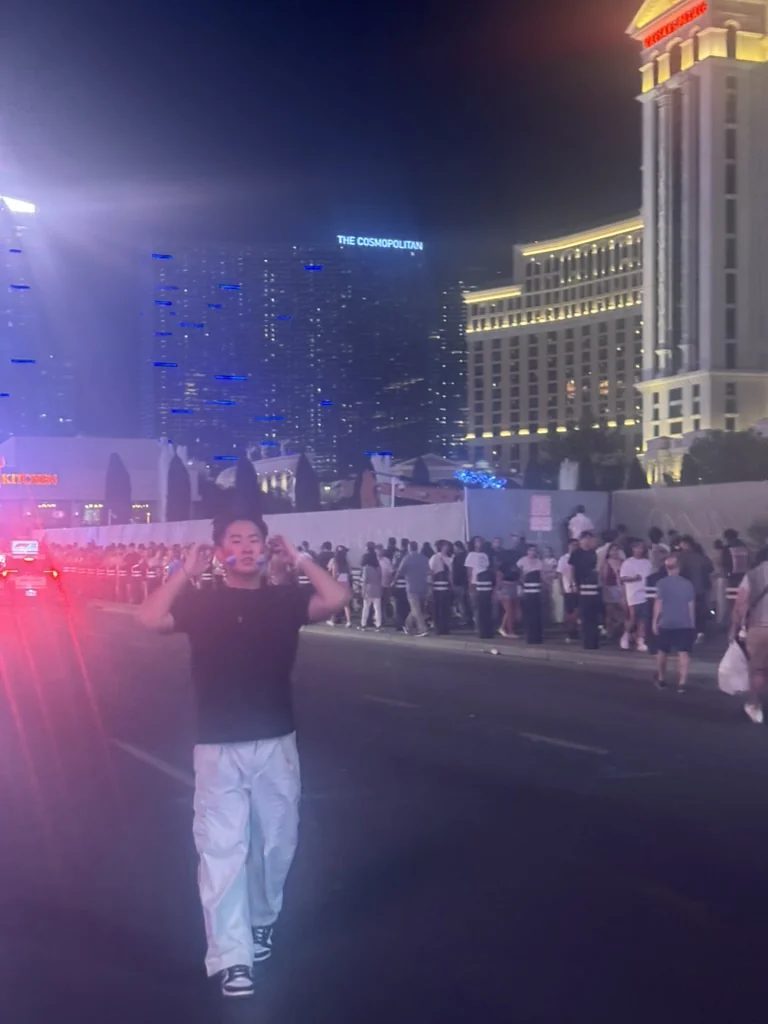 Aiden enjoying a night out near a stage